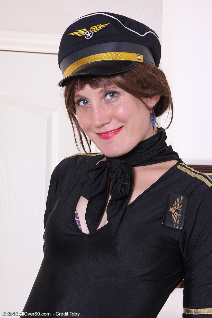 Passionate Redhead Katrina Mathews is Clothed Up As a Beautiful Airline Pilot